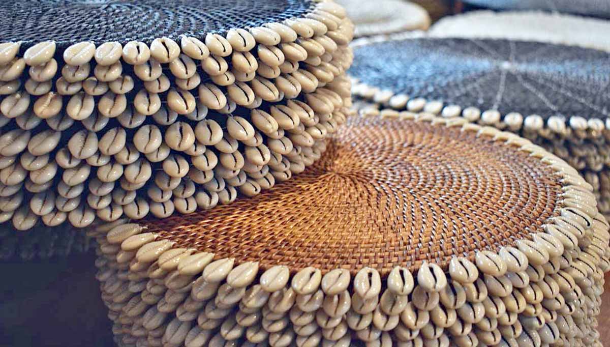 Natural rattan placemats with cowrie shell edge detail